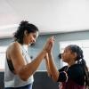 proud mom with tween daughter in a boxing gym