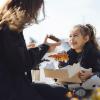 mom and daughter sharing a sweet treat on a playground near Tacoma