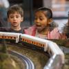 kids watching a model train at the Washington State History Museum, one of the many things for families to do this weekend near Seattle