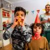 Family with two boys with blowers celebrating new years eve events in Seattle