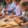 Children rolling out cookie dough for a holiday family tradition