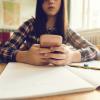 young student looks at her phone in class