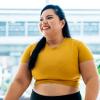 hopeful woman looks ahead to the new year in a happy yellow top