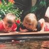 Max and Lucy Murrell looking at koi fish as chidlren