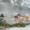 Adults and kids in a natural hot spring