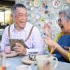 Couple laughing and making pottery together