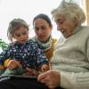 Grandma, mom and child sitting together