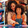 mom and daughter playing air hockey for an afternoon of retro fun in Seattle