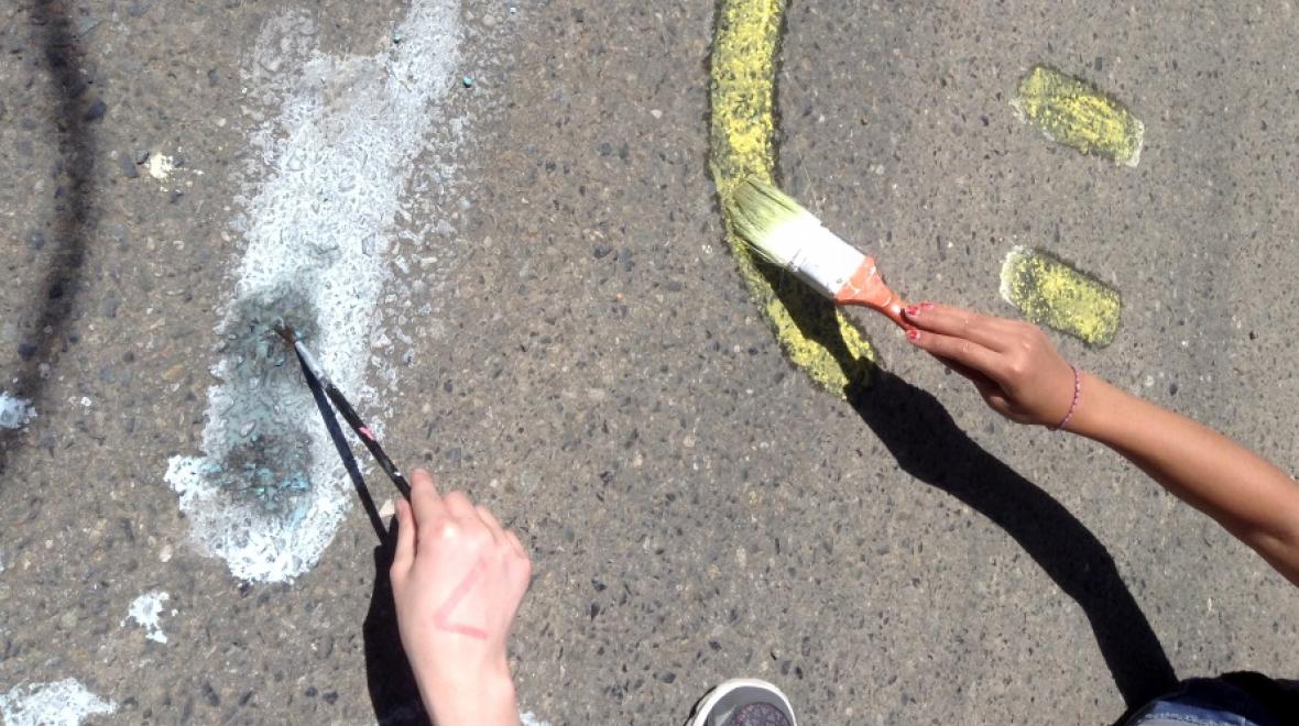 Liquid chalk paint is an unusual water activity for kids