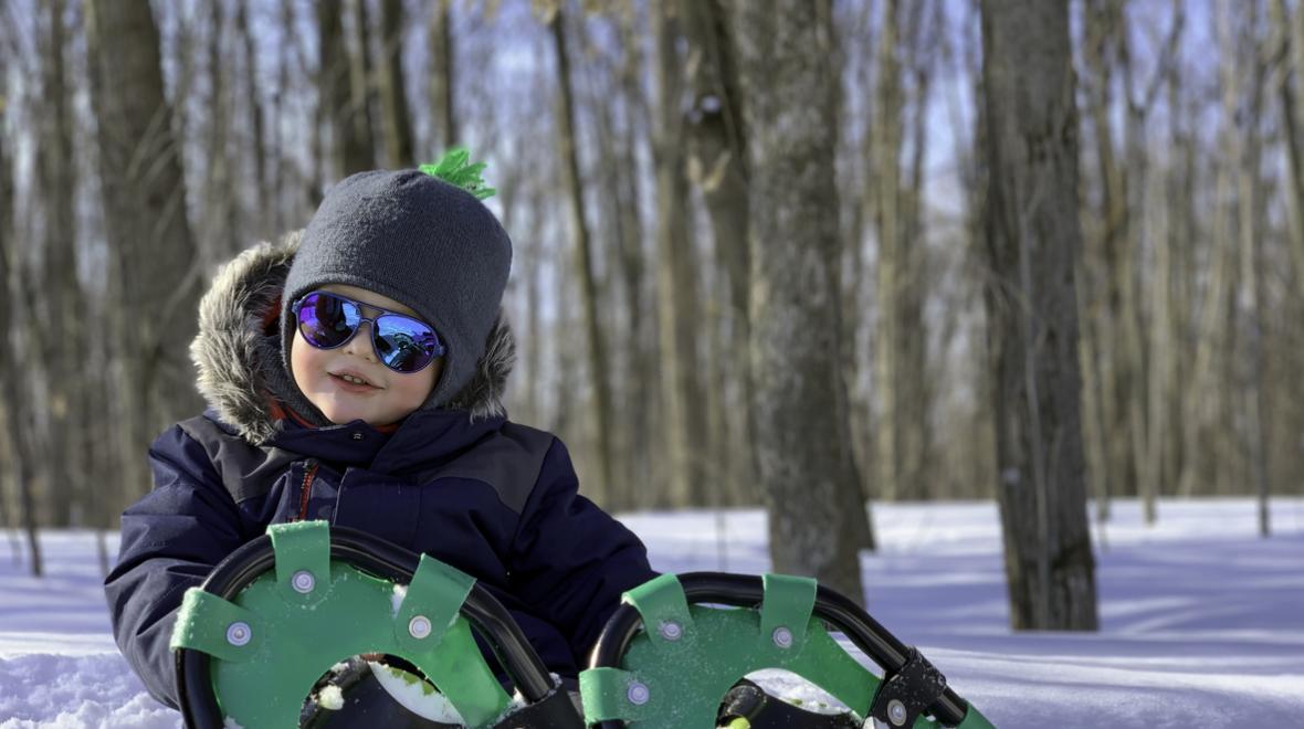 Boy-in-sunglasses-snowshoes-snow-family-snowshoeing-guide-tips-getting-started