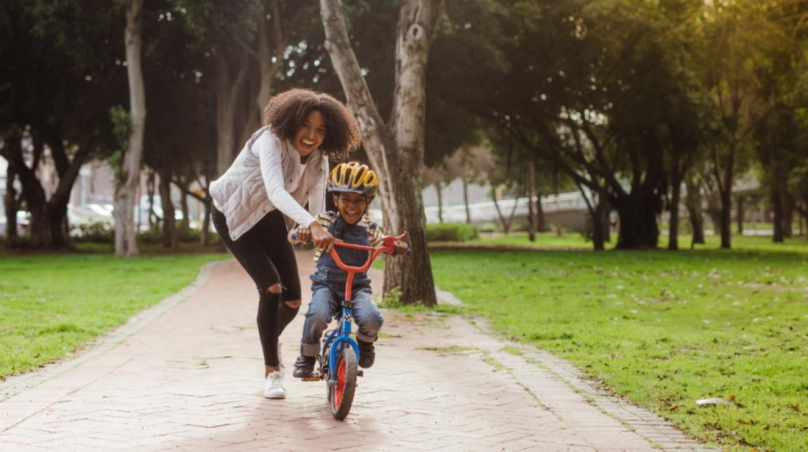 Learning to ride a store bike with training wheels