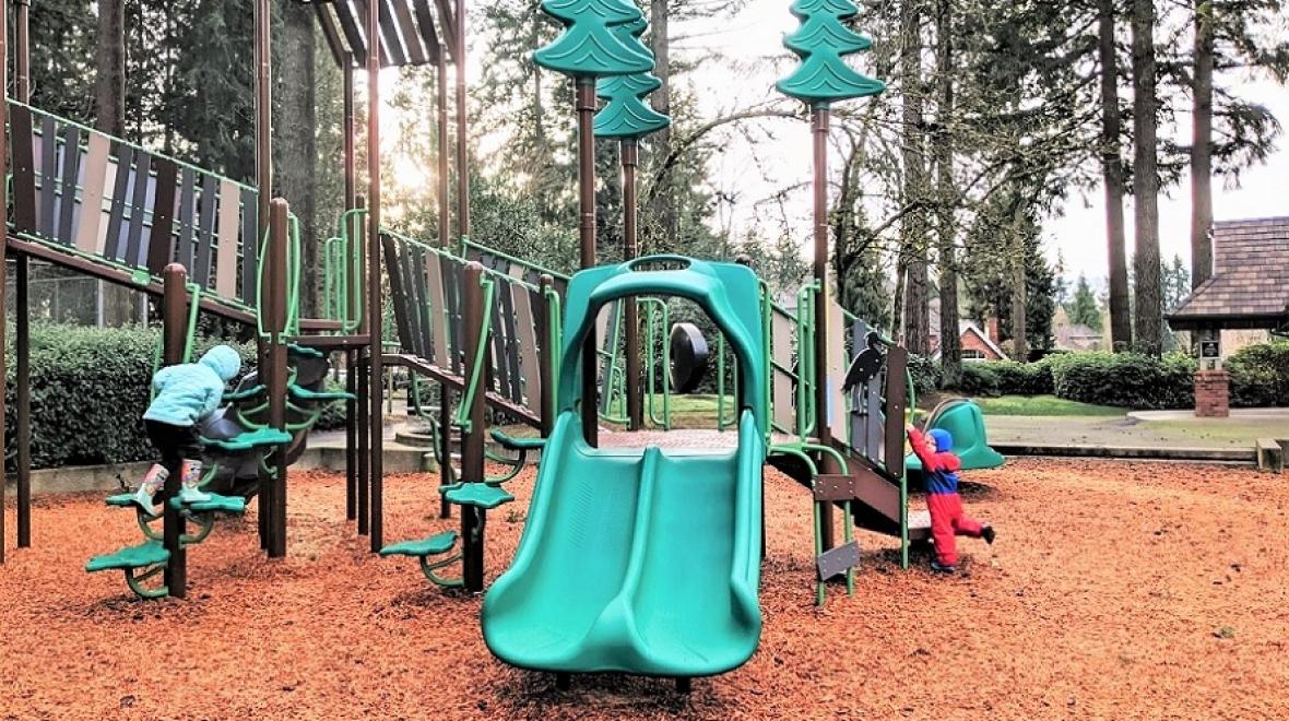 Kids play on the play structure at new neighborhood Heron Park in Mill Creek Washington between Seattle and Everett best new playgrounds kids families