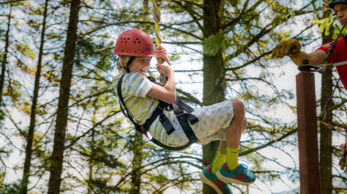 Young blonde boy zip lining at Skamania Lodge