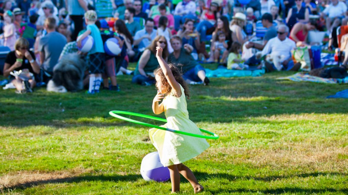 Girl plays with hula hoop at a Celebrate Woodinville a Seattle concert series in the summer