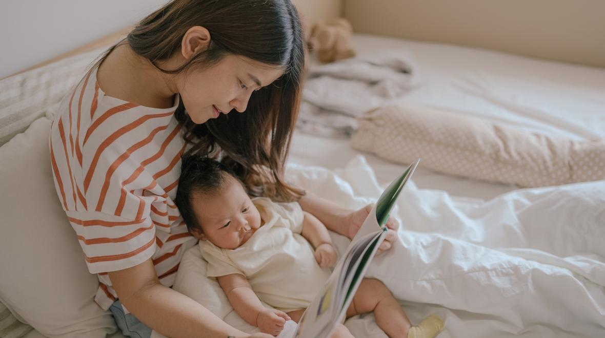 mom ready a book to her baby that they got from a baby subscription box