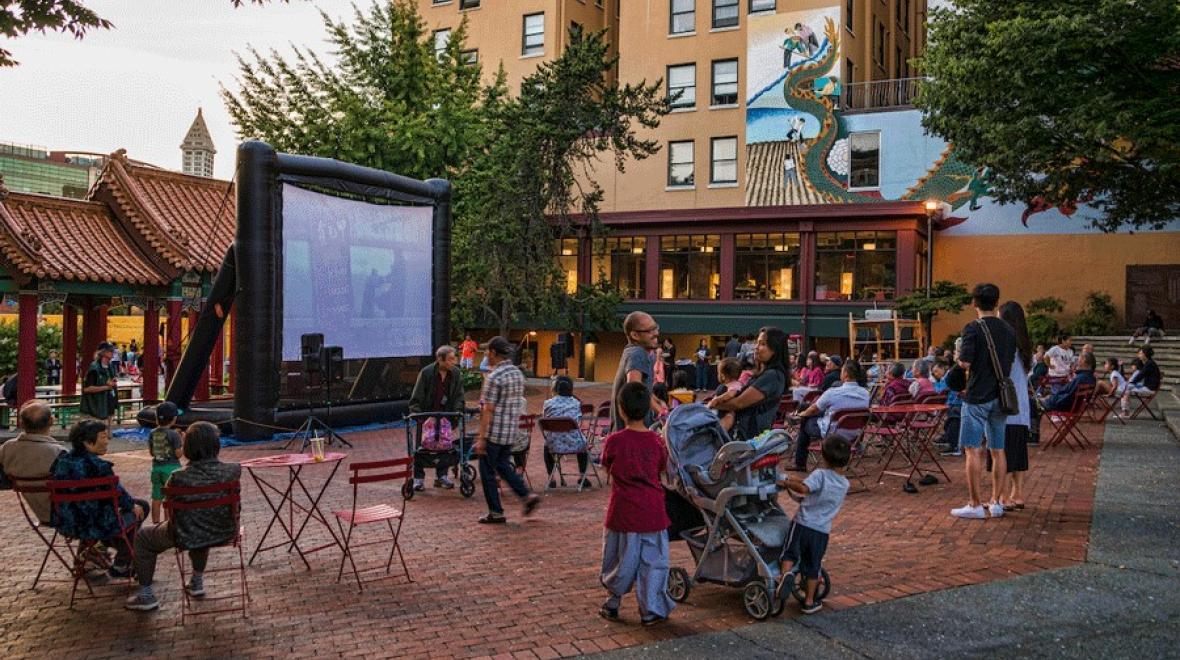 Families enjoying an outdoor movie in Seattle this summer at a local park