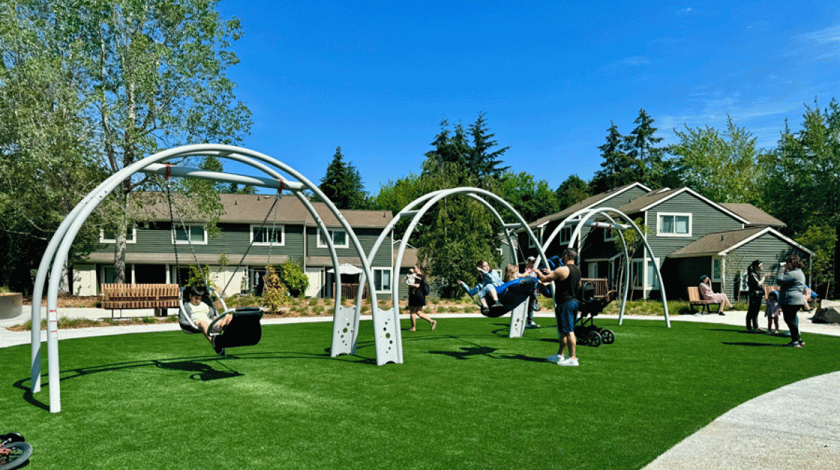Kids of all abilities play on the swings at Pathways Park in Seattle, an inclusive park with a playground