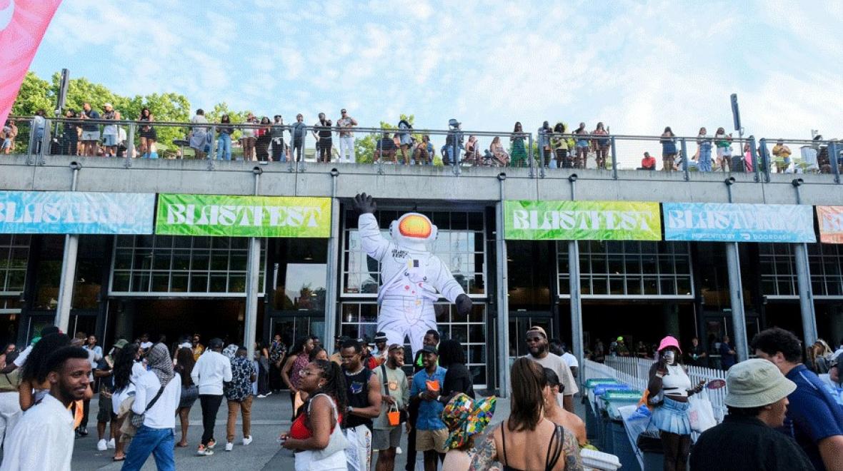 Large astronaut and crowd outside of BLASTFEST, a Seattle Music Festival