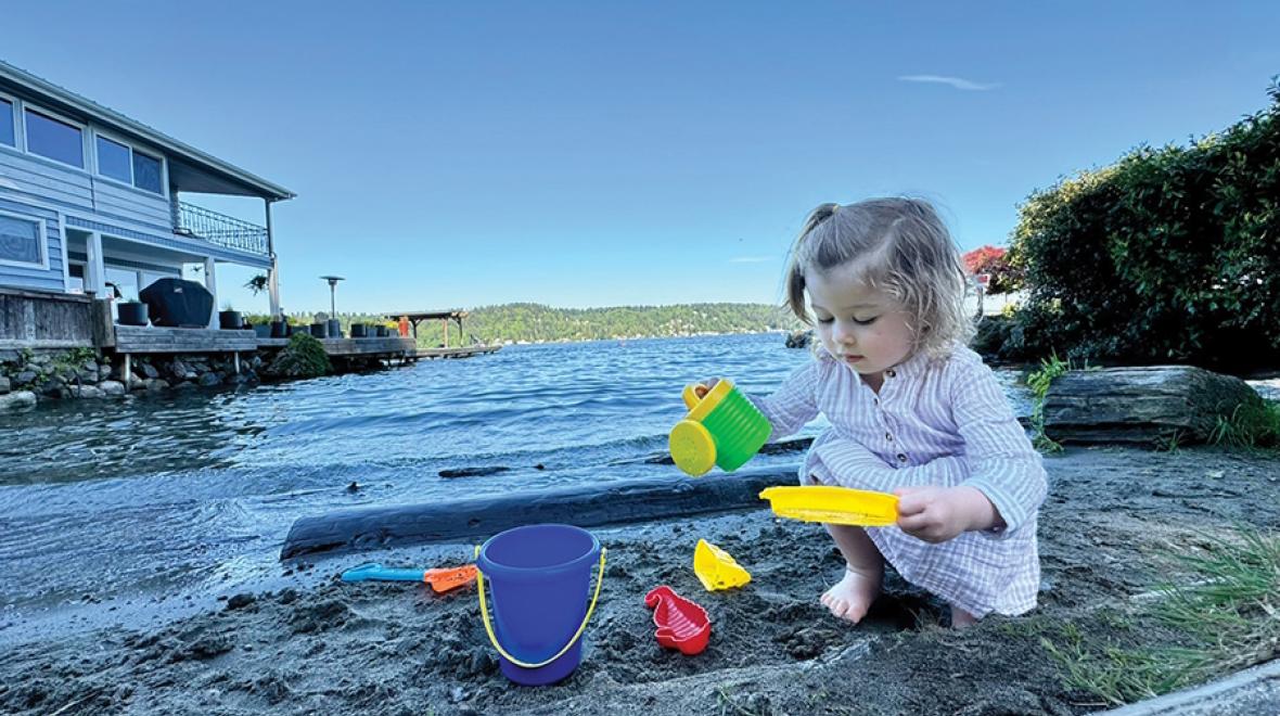Little girl playing at a secret beach in Seattle