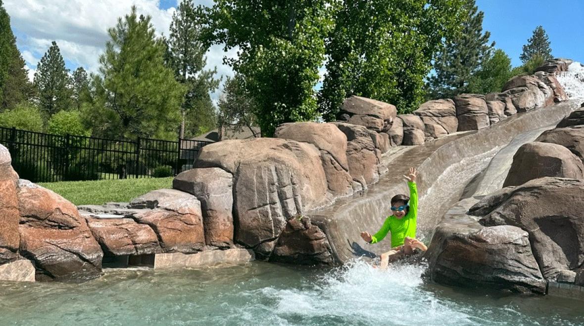  Young child slides down the waterslide at Sunriver Resort in Sunriver, Oregon