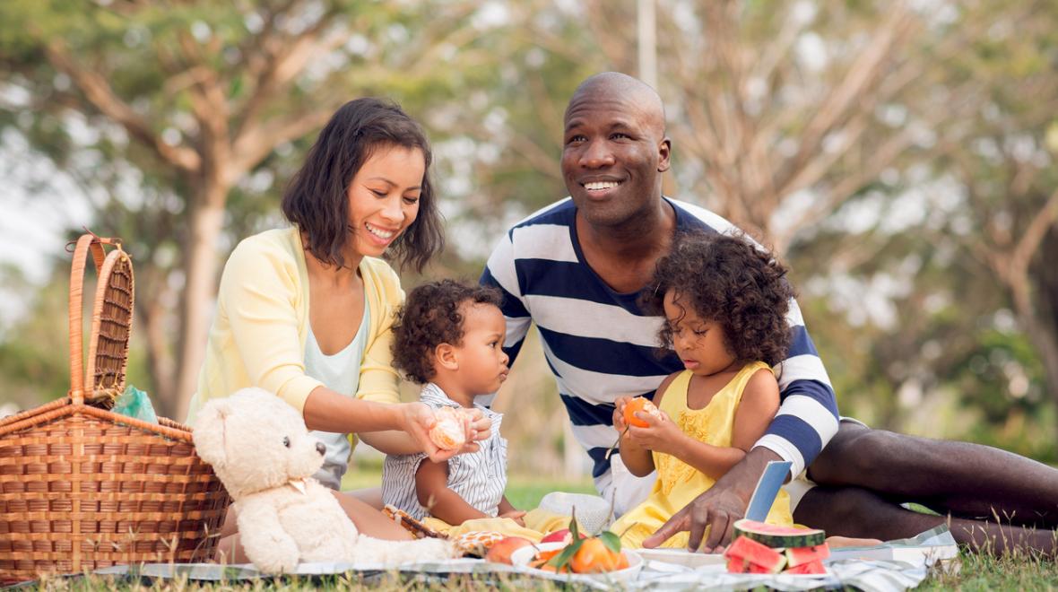 a family with a child enjoys a delicious and easy picnic in a Pacific Northwest Park