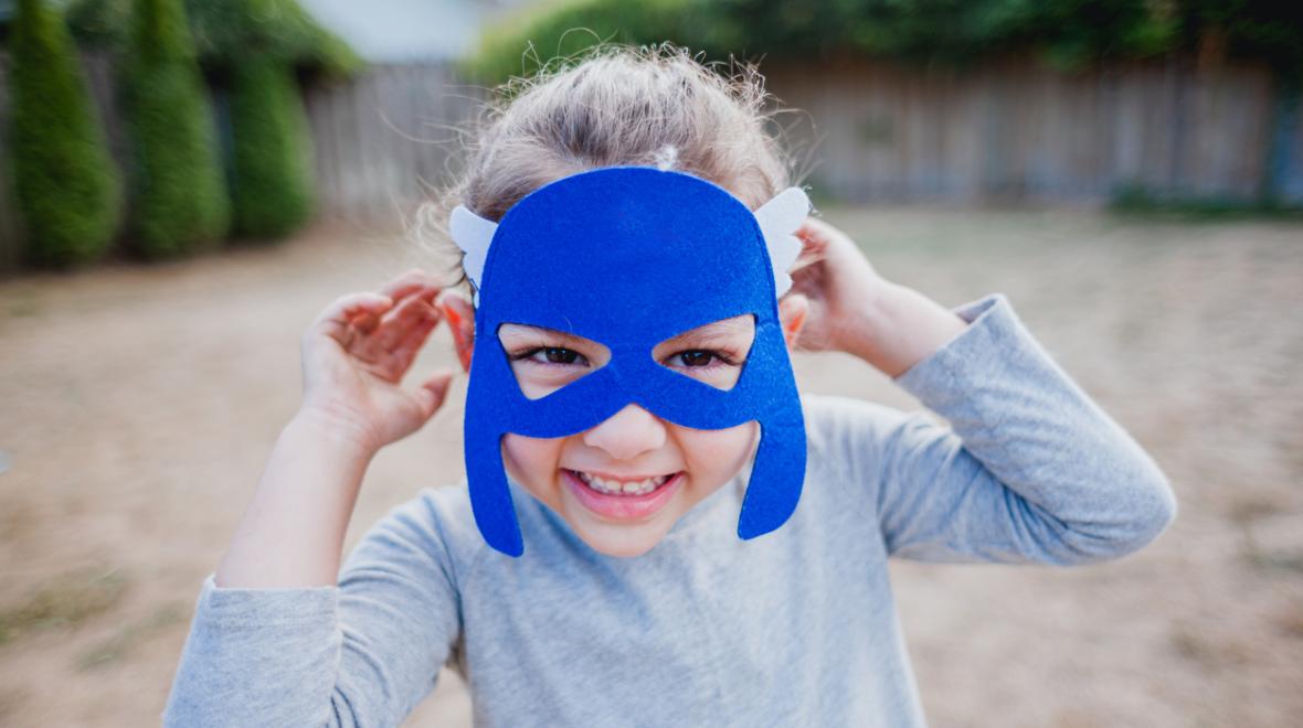 a child wears a superhero felt mask from a DIY birthday goody bag