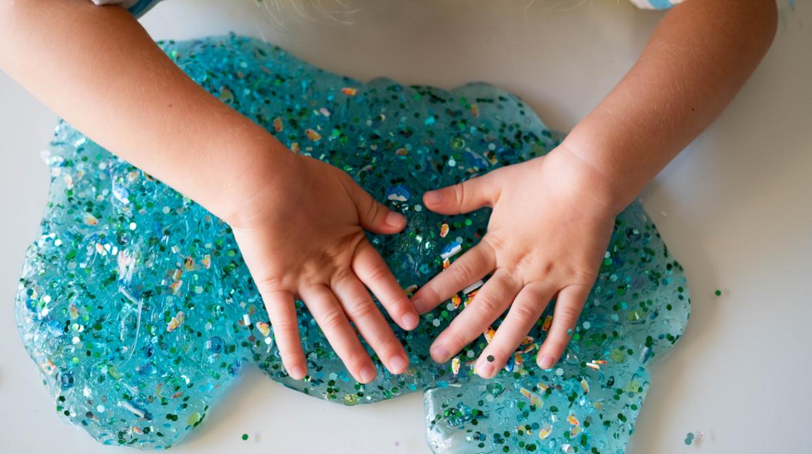 a child plays with DIY glitter slime from a birthday goody bag