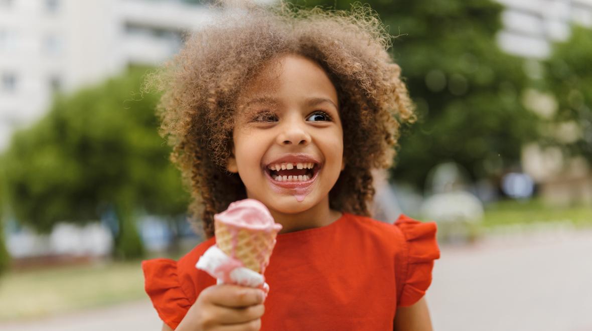 a child enjoys a birthday ice cream cone