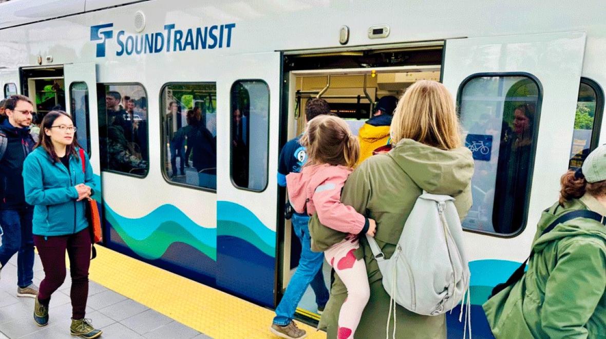 A mom and daughter wait to board the East Link Light Rail for a train adventure