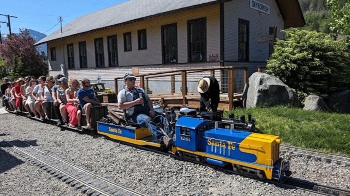 A mini train chugs along the tracks of the Great Northern & Cascade Railway in Skykomish, near Seattle