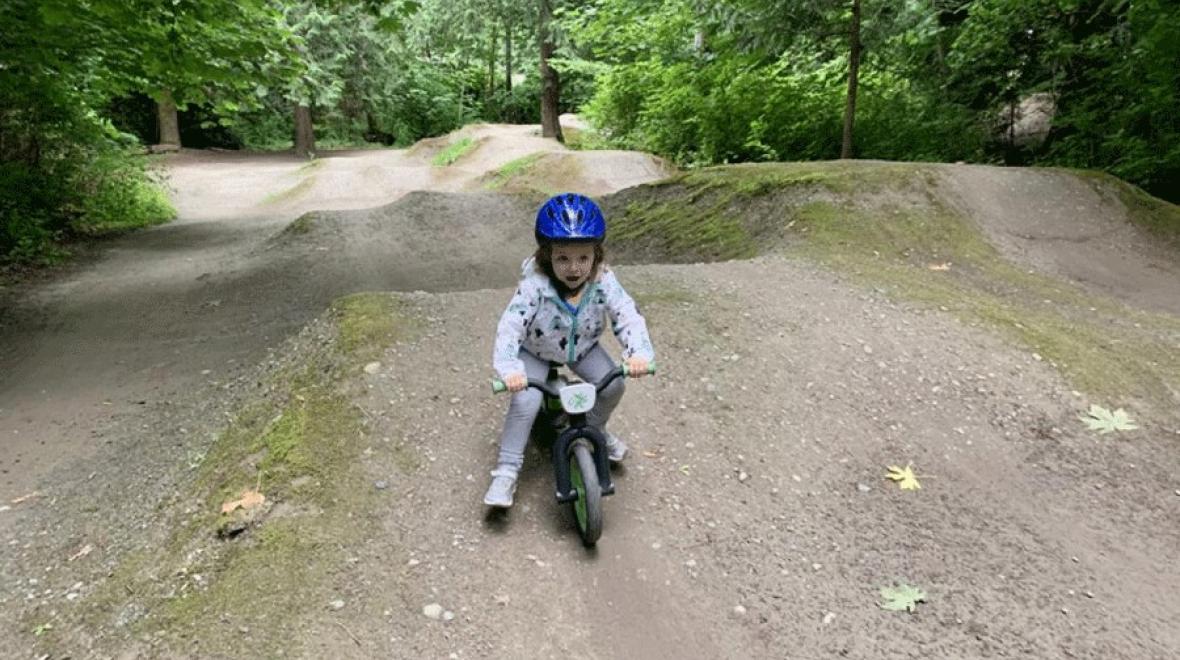 Young girl riding pump track at Redmond Bike Park, a Seattle-area pump track