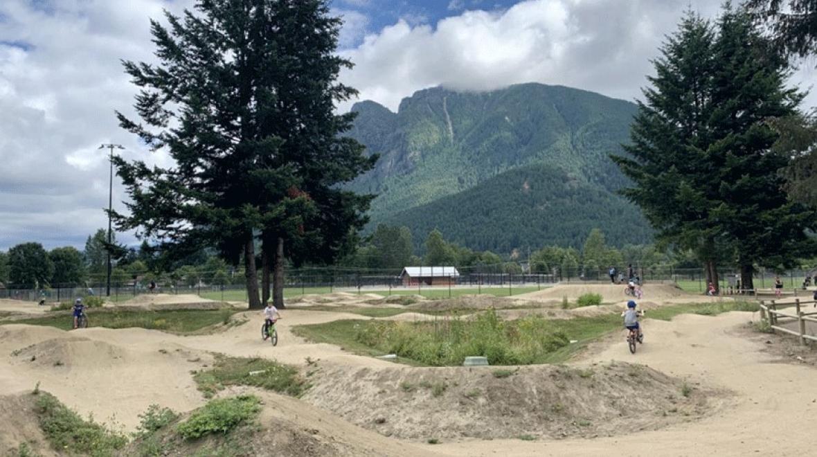 Kids riding the pump tracks at Torguson Park in North Bend, a Seattle-area pump track