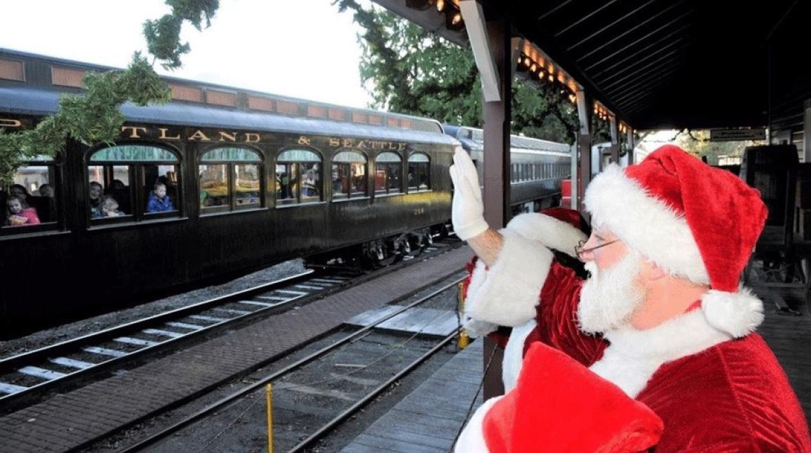 During a Santa train ride, Santa waves as the Northwest Railway's Santa Limited Train rolls into the station