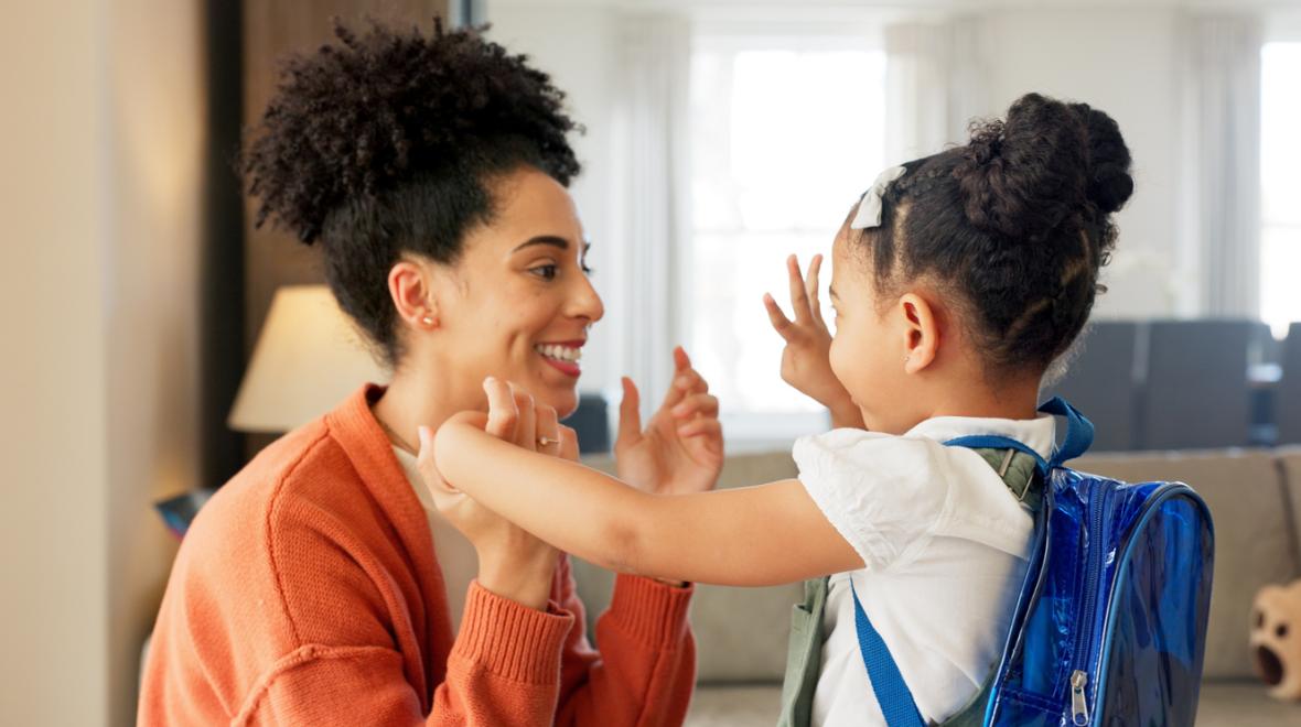 mom and child say goodbye as the child goes back to school