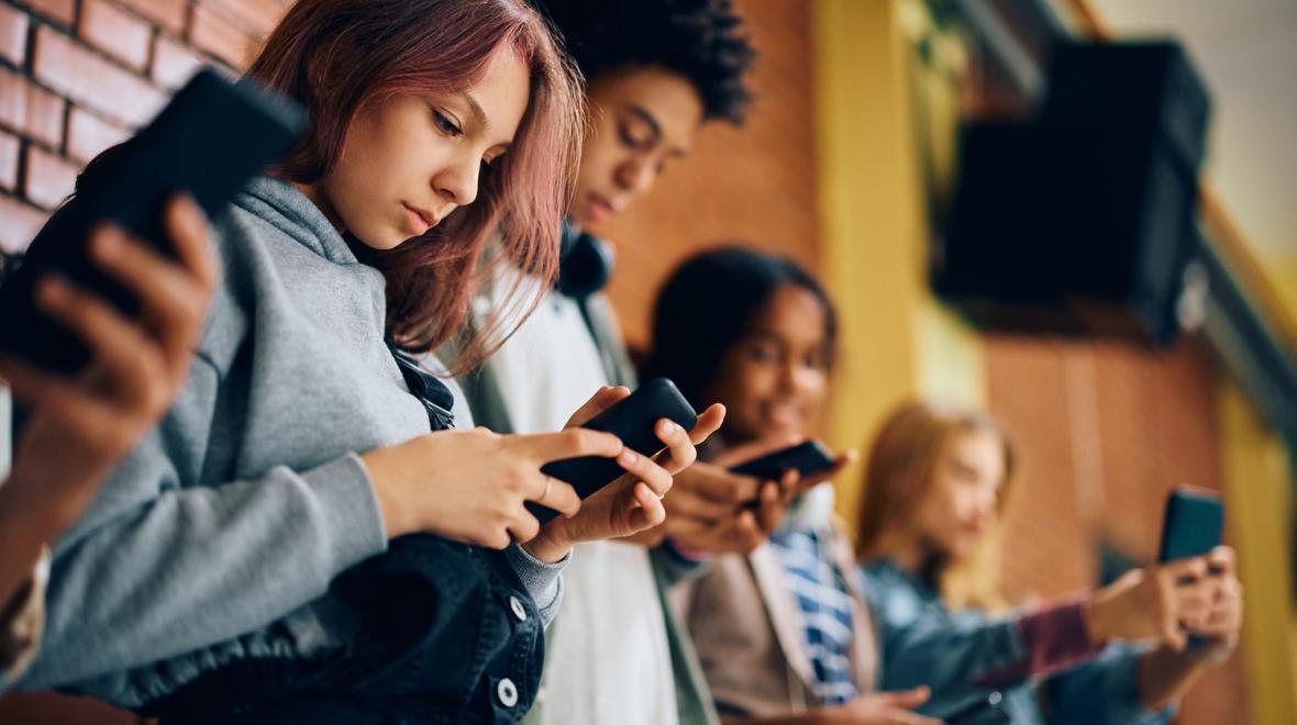 teen students using phones at school