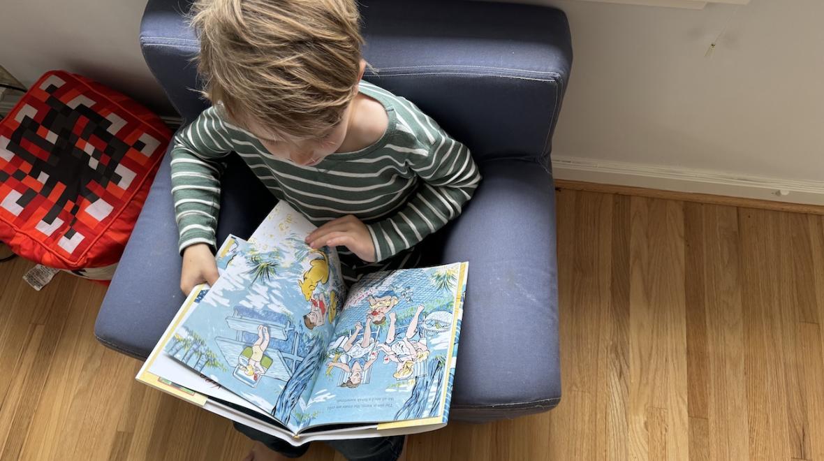 boy reading The Days Are Long, the Years Are Short a kids book about the Pacific Northwest