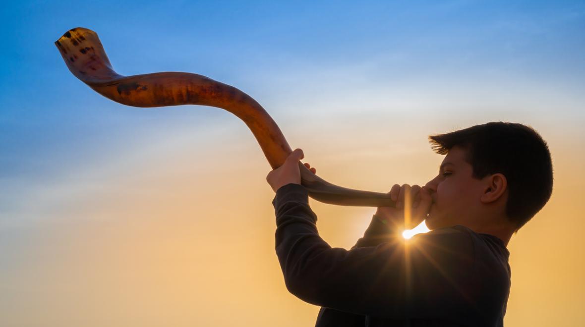 boy blows a Shofar