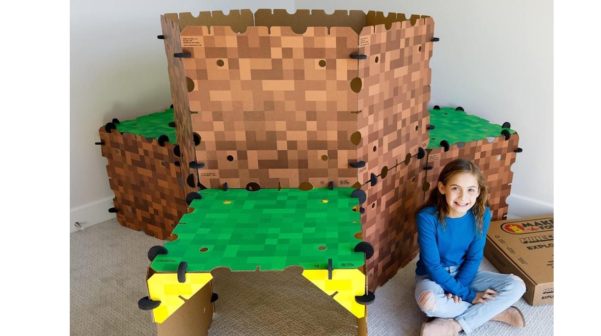 Girl sitting next to a minecraft fort