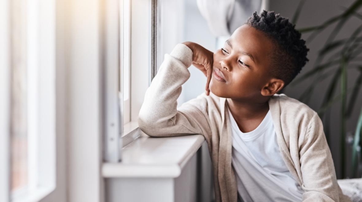 boy looking out a window