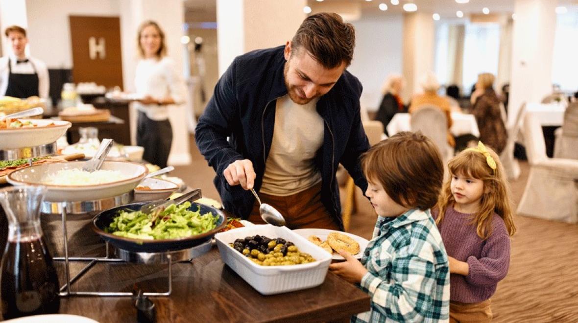 Father helping children at a Seattle Thanksgiving buffet