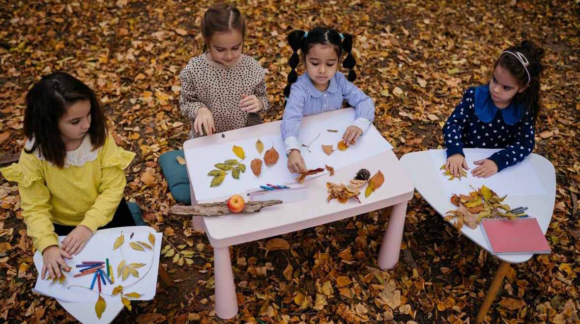 Kids collecting fall leaves