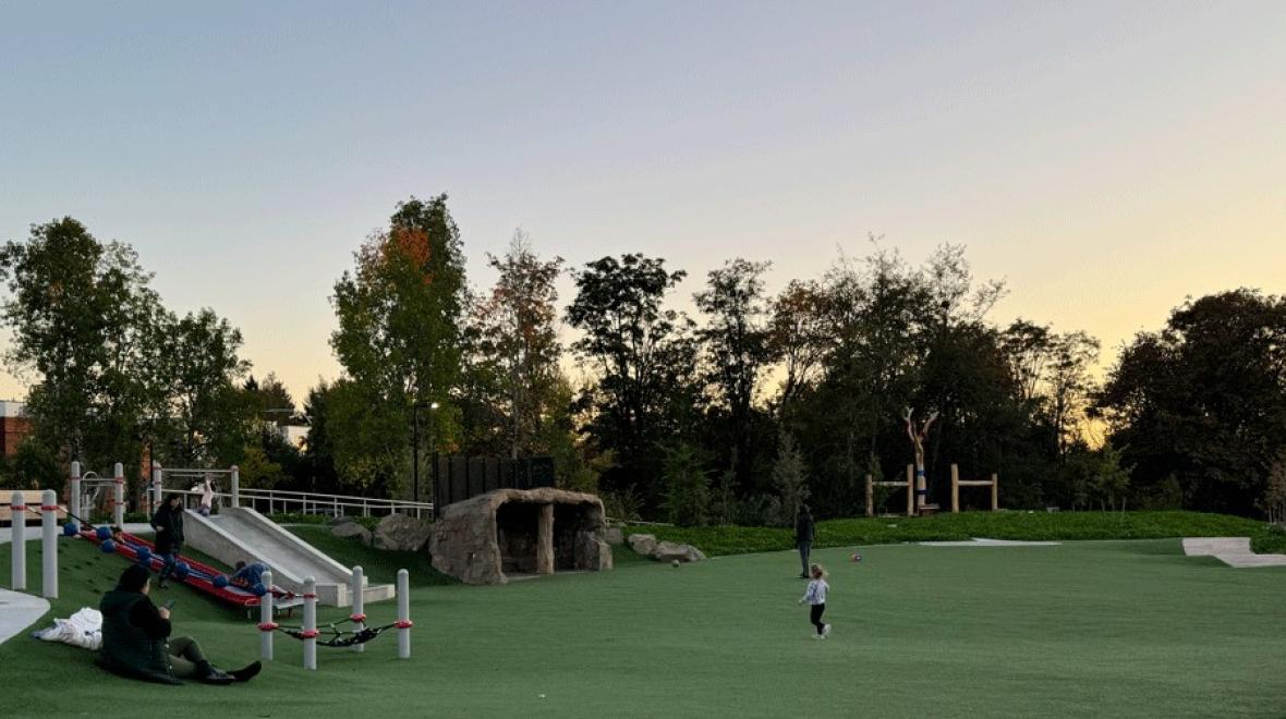 Young girl running in open space at Pathways Park, a lighted Seattle playground