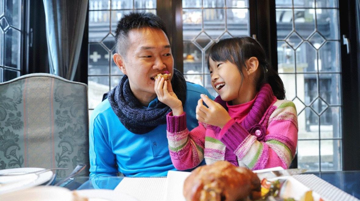 Father and daughter eating Thanksgiving dinner at a local restaurant serving Thanksgiving meals near Tacoma