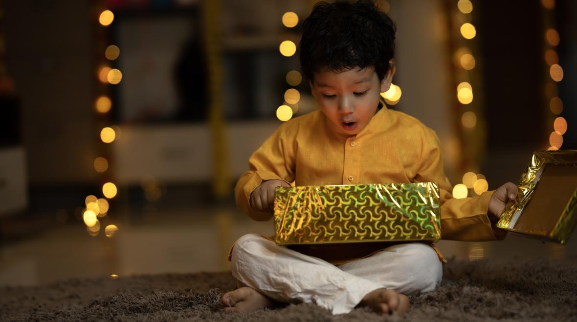 Child opening the perfect holiday gift