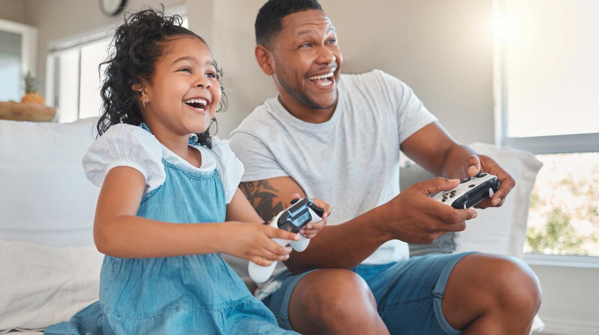 Dad and daughter playing video games