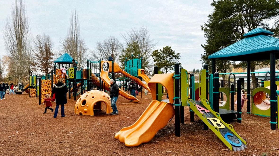 Family playing on the playground at Gene Coulon Memorial Park, an Eastside playground