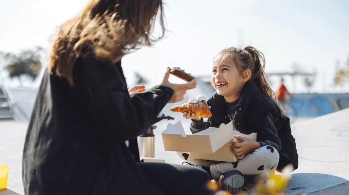 mom and daughter sharing a sweet treat at a Tacoma playground