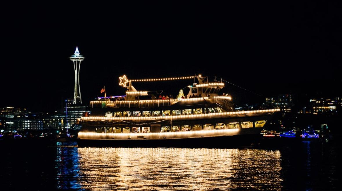 Argosy Christmas cruise ship on Elliot Bay with a view of the Space Needle, a fun Seattle holiday tradition for families