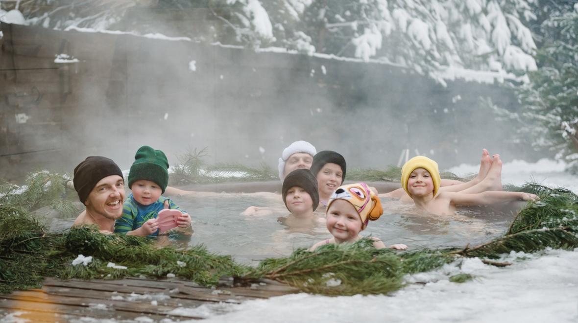 Adults and kids in a natural hot spring