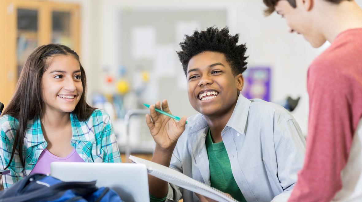 Students in a classroom working and engaging together with no cell phones